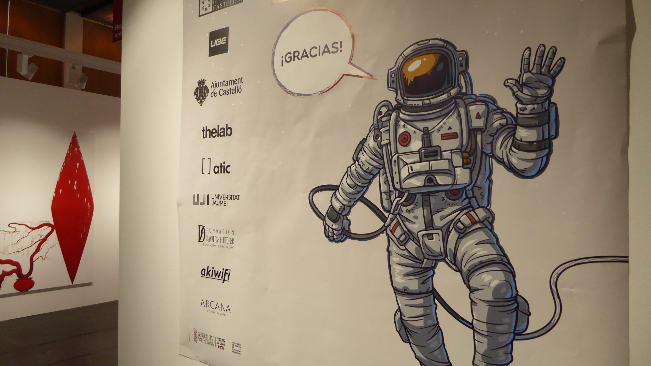 Cartel de agradecimiento de la Feria MARTE con un astronauta ilustrado y los logos de los patrocinadores, entre ellos akiwifi