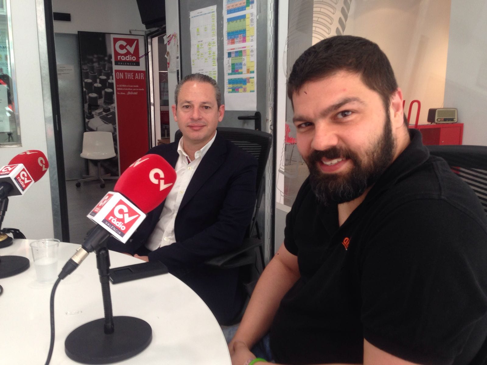 Dos hombres sentados ante los micrófonos de CV Ràdio Valencia durante una entrevista